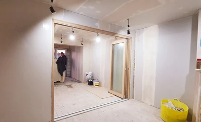 Craftsmen working on interior wall repairs