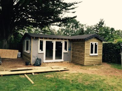 Small building with large windows under construction